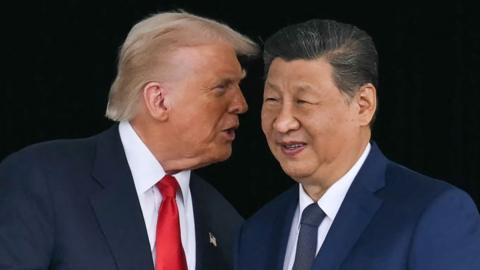 Donald Trump talking into Xi Jinping's ear, they are both wearing suits