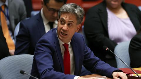 Britain's Foreign Secretary Ed Miliband attends a meeting of the United Nations Security Council, wearing a blue suit and red tie.