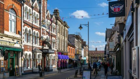 A street with lots of independent shops at either side