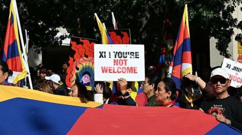 A Free Tibet protest in Washington DC. A sign reads 'Xi, you're not welcome'.