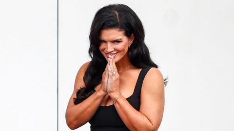 Gina Carano gestures during a news conference to promote her bout with Ronda Rousey