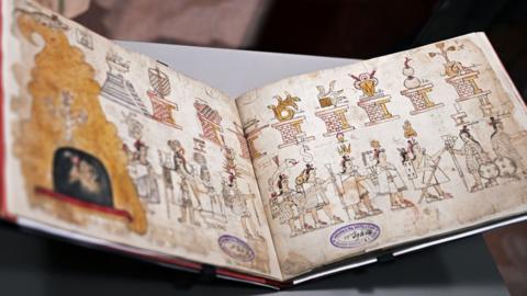 The manuscript, known as Codex Azcatitlán, is seen on display.