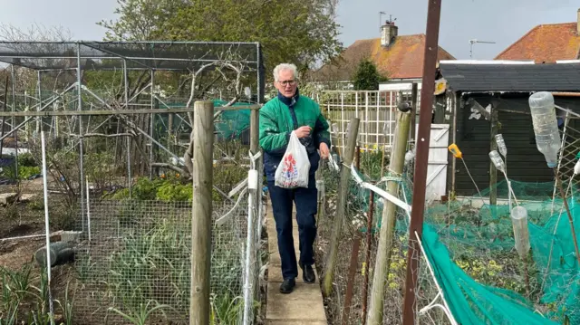 Tim Gillet walks in his allotment