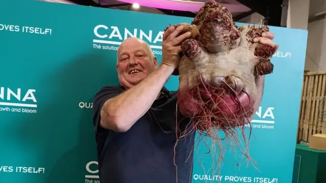 Vincent Sjodin's holds his world record breaking beetroot above his head