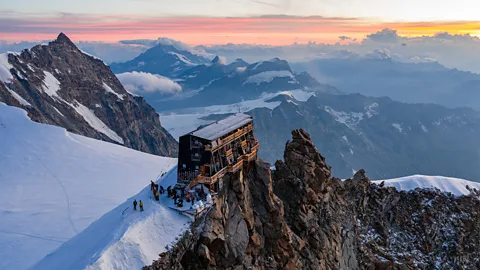 A mountain hut at the top of a peak at sunset (Credit: Jianpeng Cui)