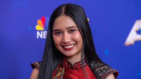 Nene Royal wearing a red dress 