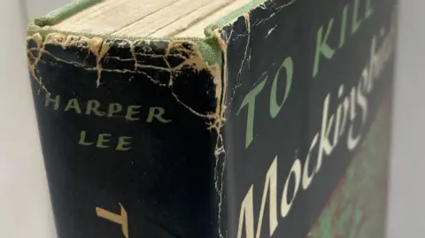 A close-up of the top half of a hardback book