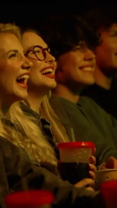 Young people in a movie theatre. 
